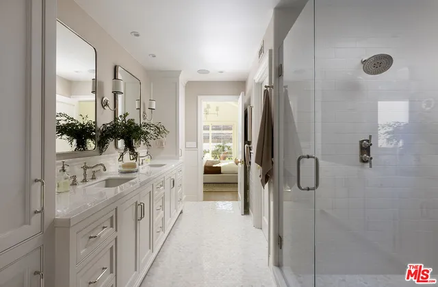 a bathroom with double vanity sink and a mirror