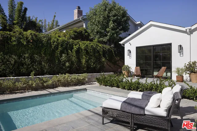 a building outdoor space with patio furniture and potted plants