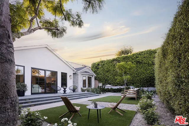 a view of a house with backyard sitting area and garden