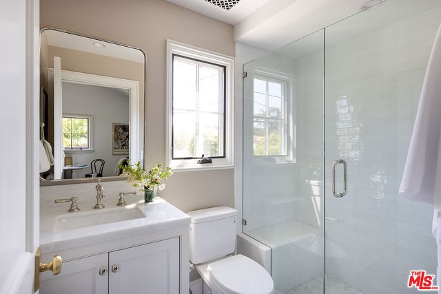 a view of a patio with couches table and chairs with wooden fence