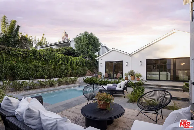 a view of a backyard with sitting area