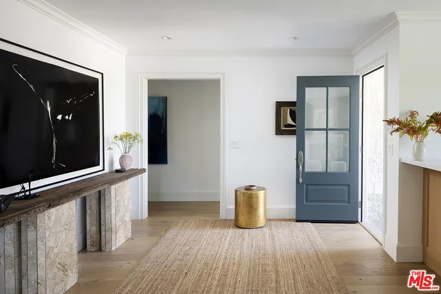 a view of an empty room with closet and a window