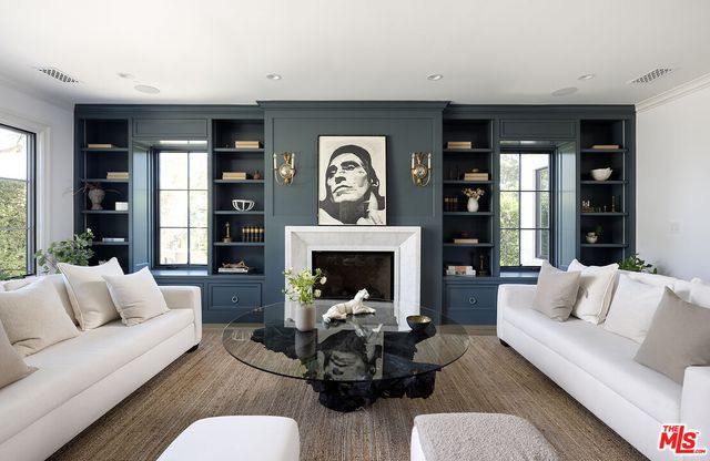 a living room with furniture a fireplace and window