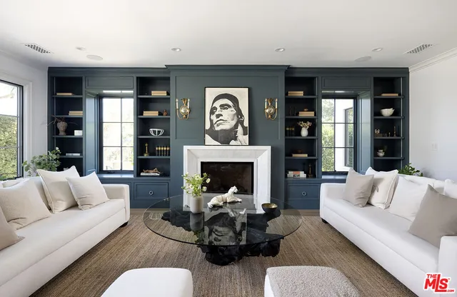 a living room with furniture a fireplace and window