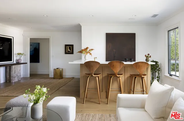 a living room with furniture a chandelier and a flat screen tv