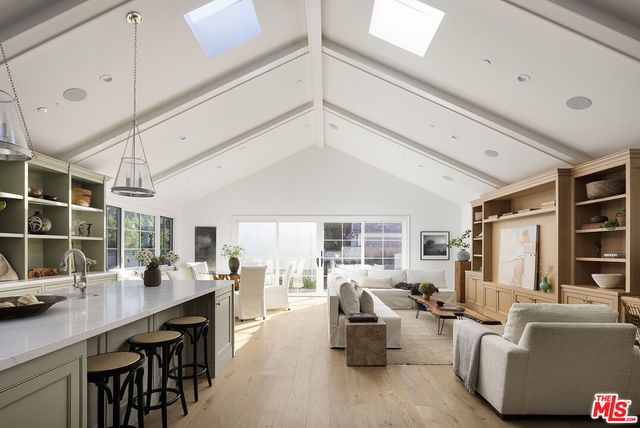 a living room with furniture a table and chairs
