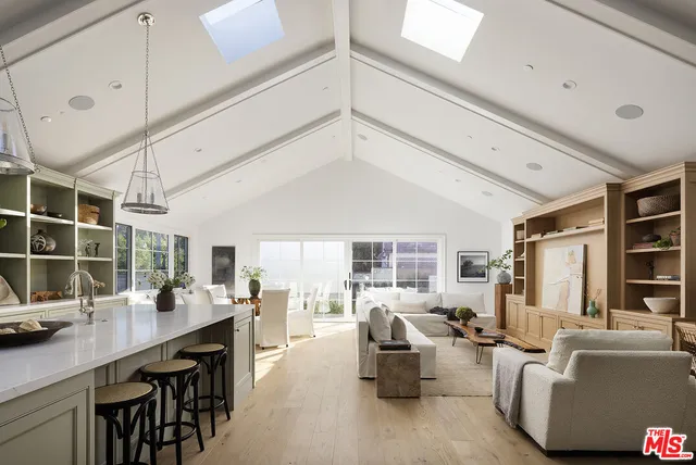 a living room with furniture a table and chairs