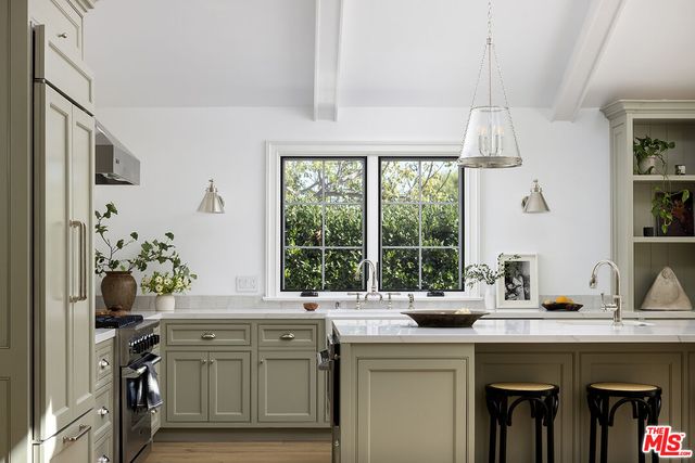 a kitchen with a sink and a large window