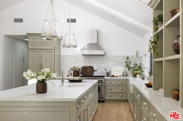a kitchen with a sink stove and cabinets