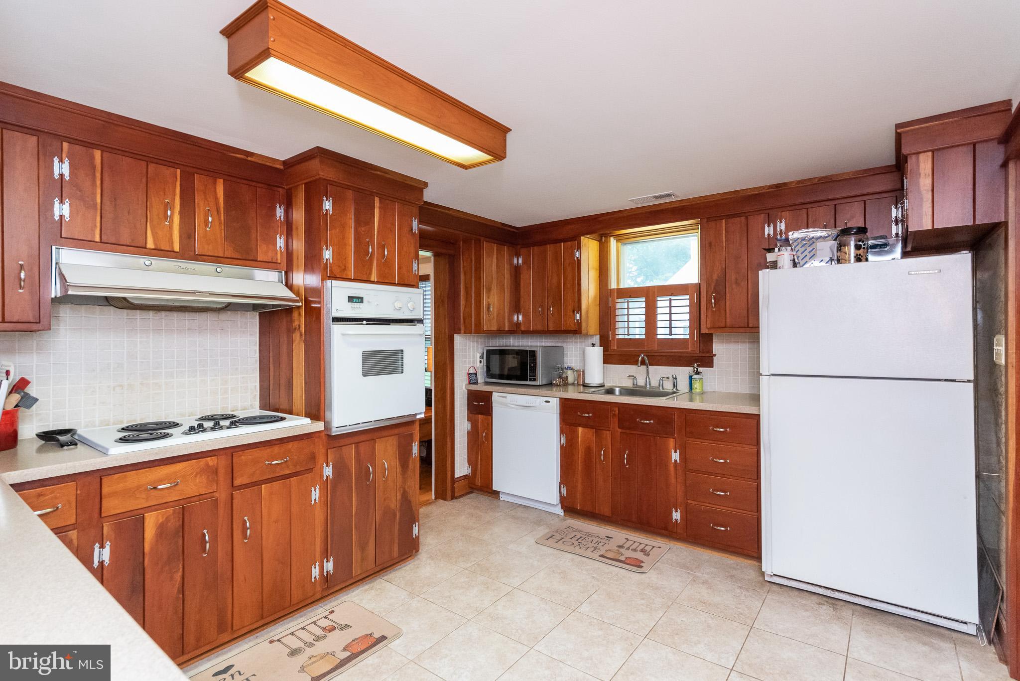 1808 Harford Road Fallston, MD 21047 - Photo 11 of 54 a kitchen with stainless steel appliances granite countertop a refrigerator stove a sink dishwasher and a microwave oven