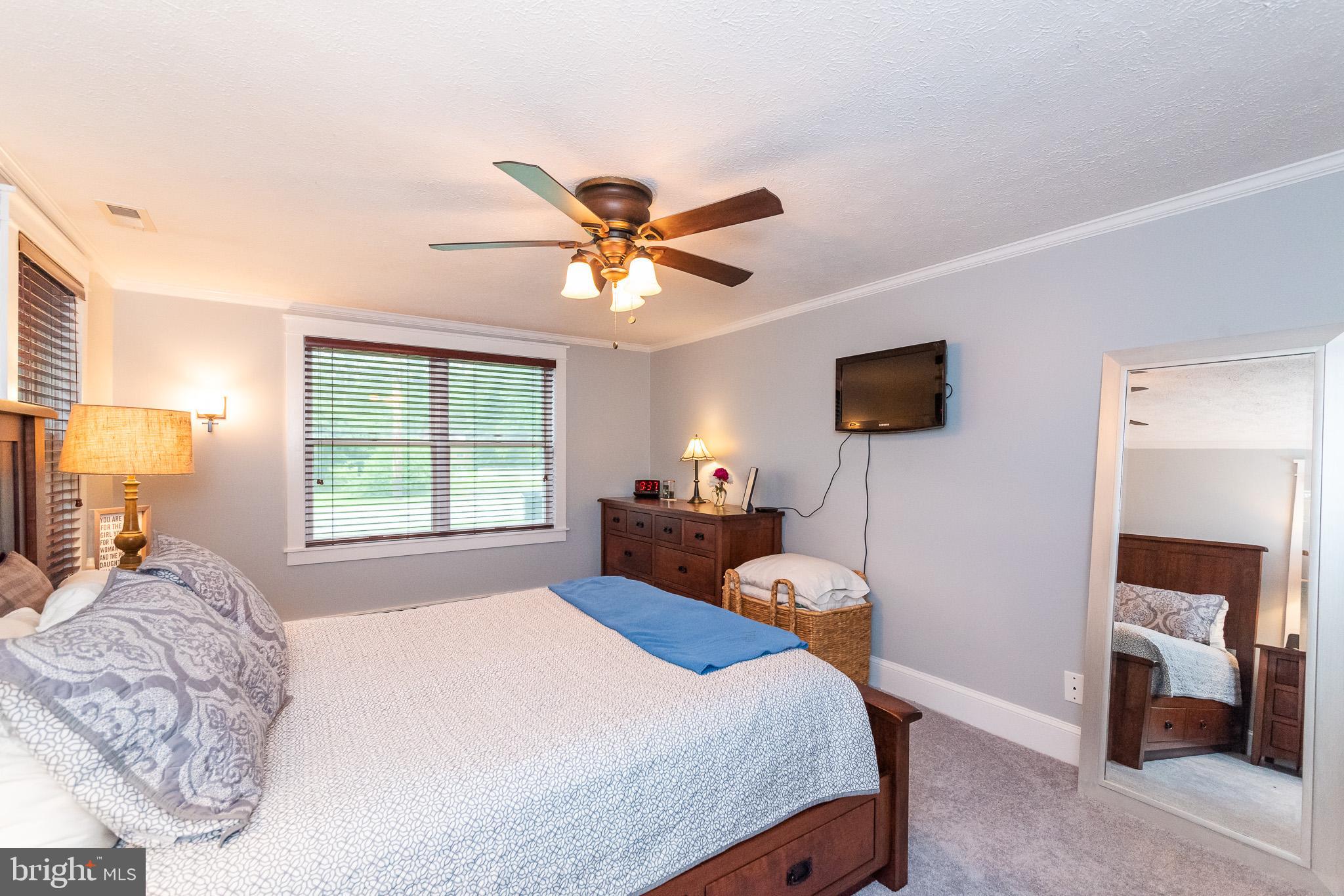 1808 Harford Road Fallston, MD 21047 - Photo 20 of 54 a bedroom with a bed and a chandelier