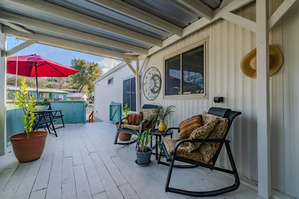 an outdoor living area with furniture and a potted plant