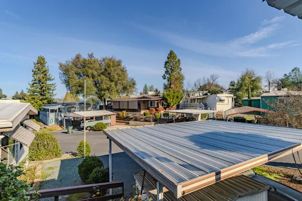 a view of a house with backyard and trees