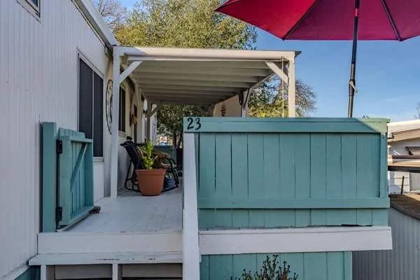 a view of a chairs and table in the backyard