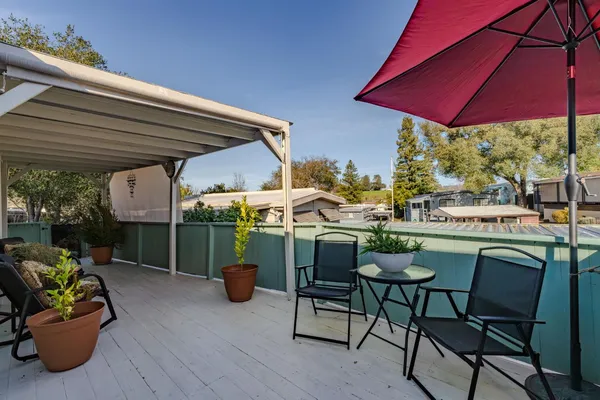 a view of a house with swimming pool and sitting area
