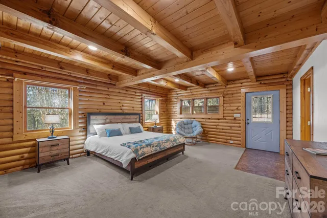 a spacious bedroom with a bed and a window