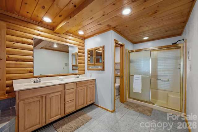 a bathroom with a double vanity sink and a mirror