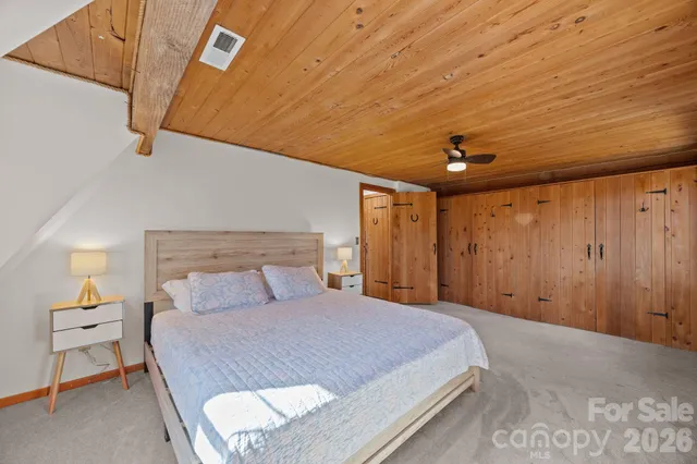 a bedroom with a bed and a night stand