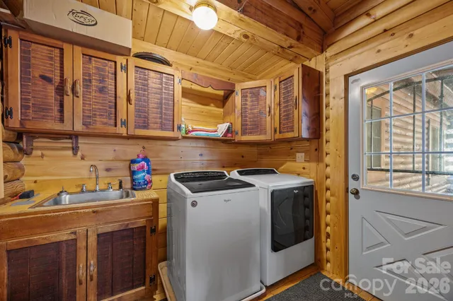 a utility room with sink dryer and washer