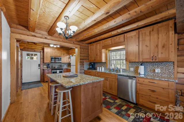 a kitchen with stainless steel appliances granite countertop a sink stove and cabinets