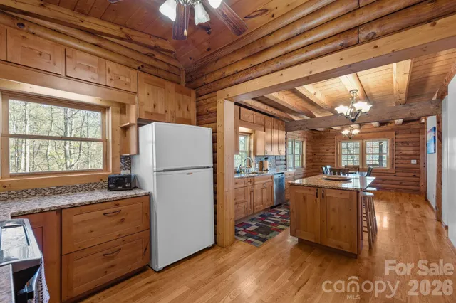 a kitchen with refrigerator and window