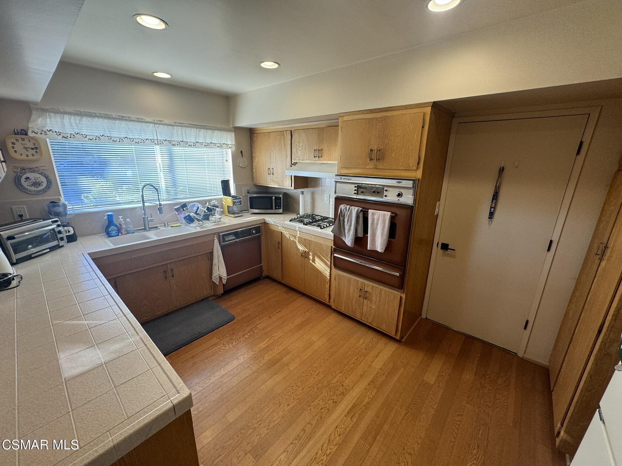 2623 Avenida Simi Simi Valley, CA 93065 - Photo 9 of 24 a kitchen with sink refrigerator and microwave