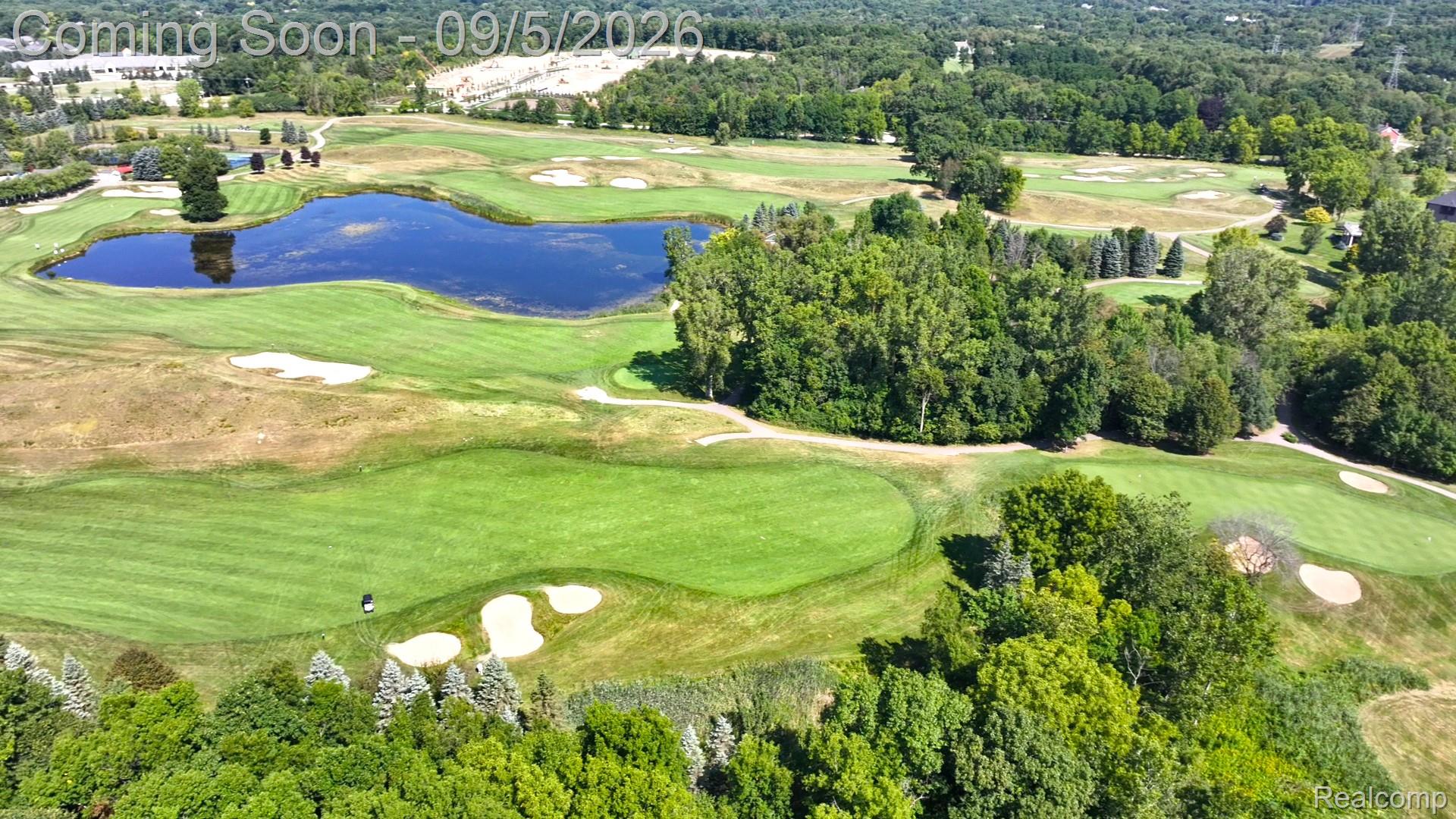 2785 Cranbrook Ridge Court Rochester, MI 48306 - Photo 85 of 97 Expansive golf course setting featuring manicured greens, sand traps, and a prominent water hazard