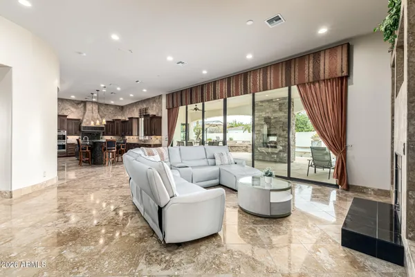 a open kitchen with stainless steel appliances granite countertop a stove a sink and a microwave