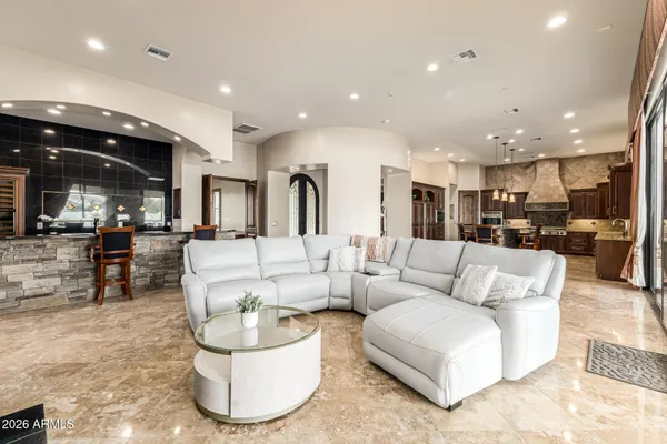 a kitchen with stainless steel appliances kitchen island granite countertop a stove a refrigerator and wooden cabinets