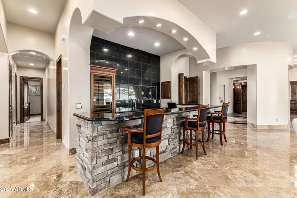 a room with a chandelier and mirror