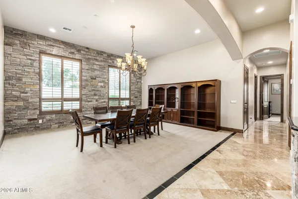 a spacious bedroom with a bed and wooden floor