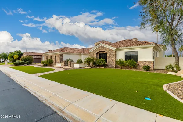 a front view of a house with a garden