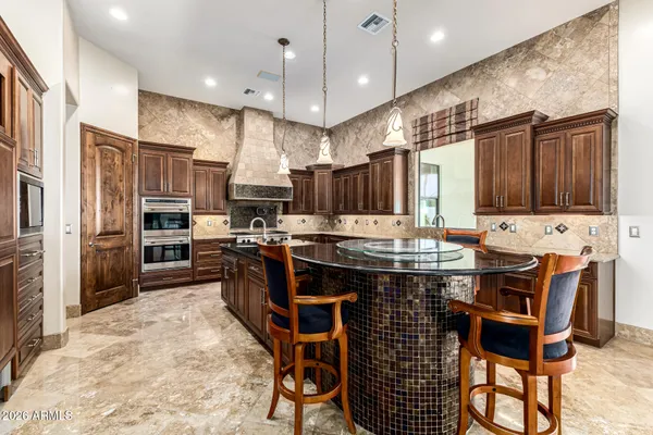a bathroom with a granite countertop sink a large mirror and a shower