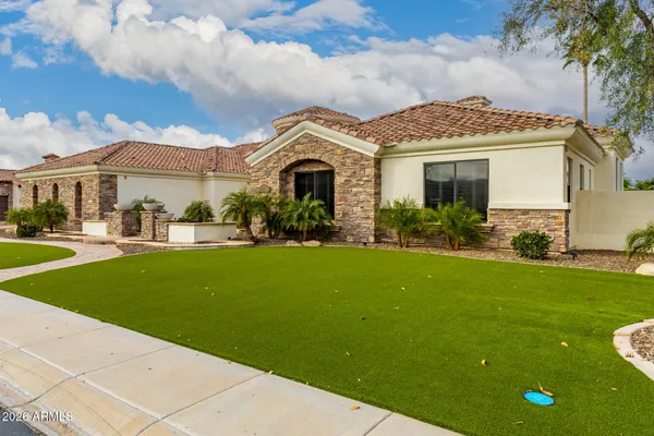a front view of a house with yard and green space