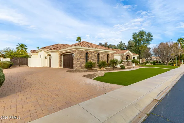 a front view of a house with a garden and plants