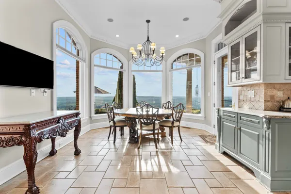 a large kitchen with kitchen island granite countertop a large counter top and a view of living room