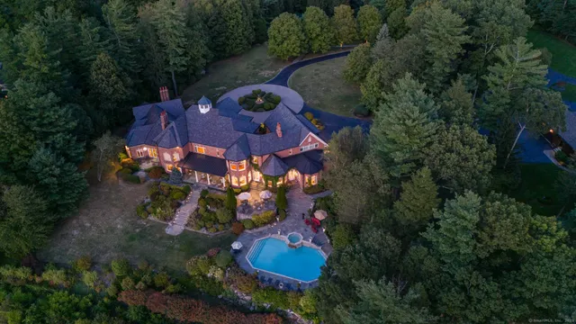 an aerial view of a house with garden space and street view