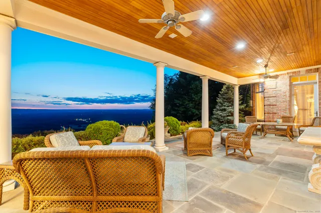 a view of a terrace with wooden floor and lake view