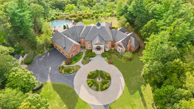 an aerial view of a house with a swimming pool