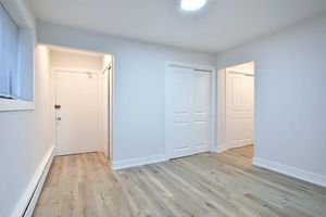 6060 North Ridge Avenue, Unit 1A Chicago, IL 60660 - Photo 11 of 25 an empty room with wooden floor and windows