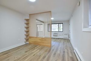 6060 North Ridge Avenue, Unit 1A Chicago, IL 60660 - Photo 12 of 25 an empty room with wooden floor and windows