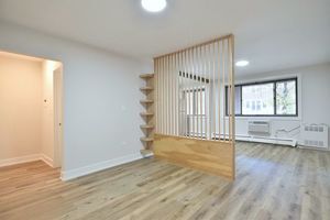 6060 North Ridge Avenue, Unit 1A Chicago, IL 60660 - Photo 13 of 25 an empty room with wooden floor and windows
