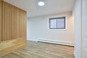 6060 North Ridge Avenue, Unit 1A Chicago, IL 60660 - Photo 14 of 25 an empty room with wooden floor and windows