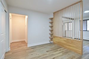6060 North Ridge Avenue, Unit 1A Chicago, IL 60660 - Photo 15 of 25 an empty room with wooden floor and windows