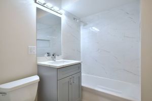 6060 North Ridge Avenue, Unit 1A Chicago, IL 60660 - Photo 16 of 25 a bathroom with a sink toilet and shower