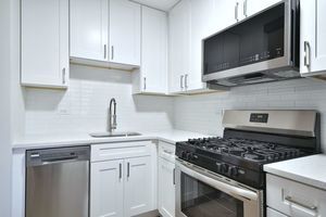 6060 North Ridge Avenue, Unit 1A Chicago, IL 60660 - Photo 4 of 25 a kitchen with white cabinets and appliances