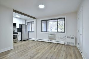 6060 North Ridge Avenue, Unit 1A Chicago, IL 60660 - Photo 9 of 25 an empty room with wooden floor and windows