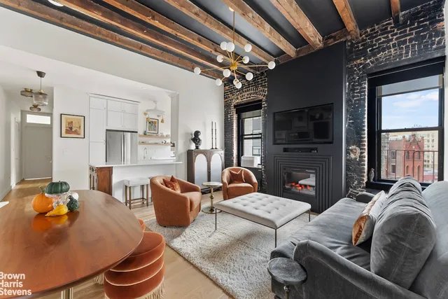 a living room with fireplace furniture and a flat screen tv
