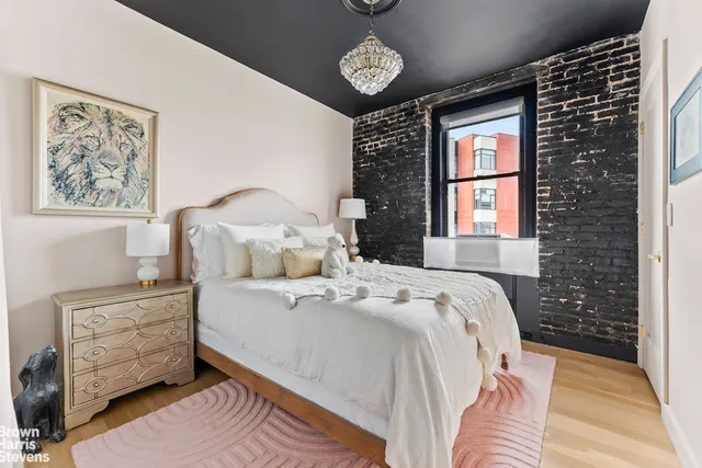 a kitchen with stainless steel appliances granite countertop a refrigerator a stove and a sink with large window