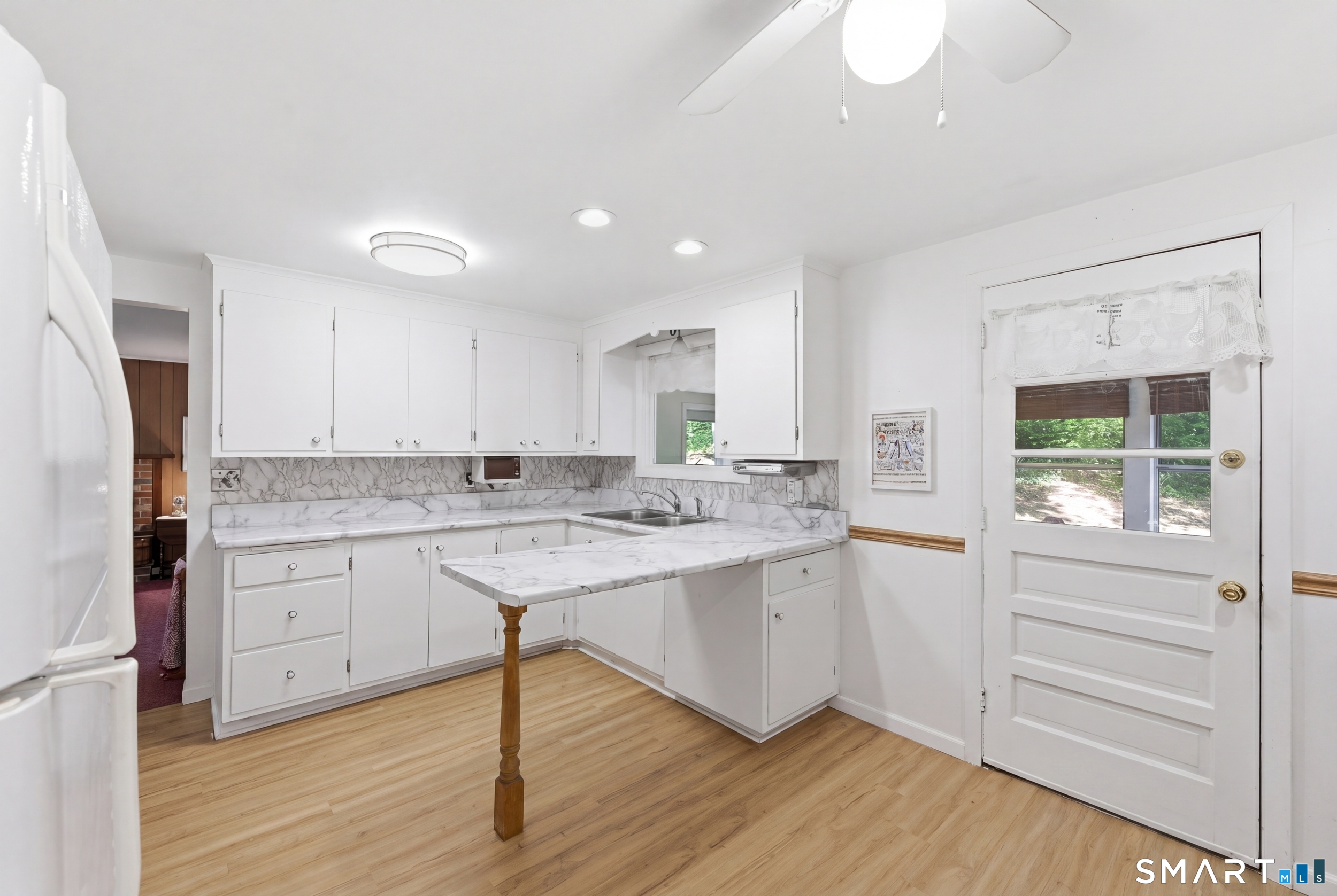 121 River Road Preston, CT 06365 - Photo 7 of 37 a kitchen with granite countertop white cabinets and white appliances